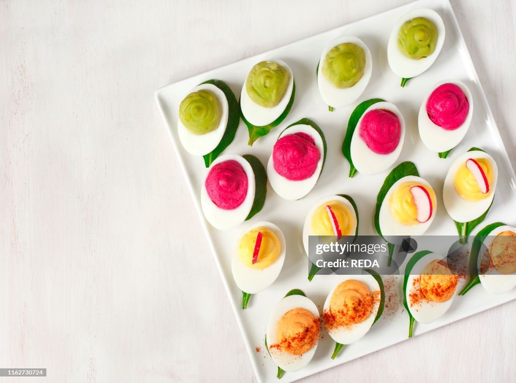 A plate of deviled eggs on dark grey stone background. top view. copy space
