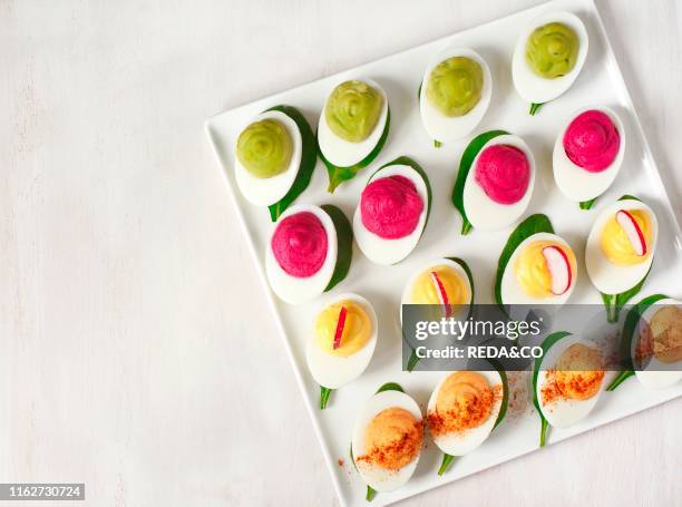 Plate of deviled eggs on dark grey stone background. Top view. Copy space.