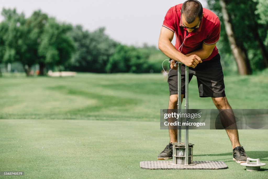 Full Length Of Man Standing On Golf Course