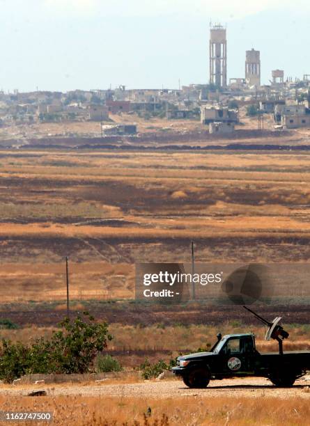 Syrian government vehicle is pictured near the town of Khan Shaykhun in the southern countryside of the rebel-held Idlib province on August 18, 2019....