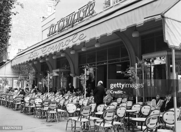 Picture taken in June 1949 of people at the terrace of La Coupole restaurant on the Montparnasse Boulevard in Paris.