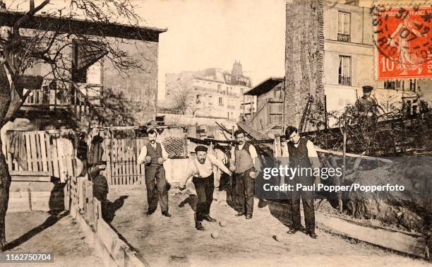 Vintage French postcard featuring men playing a game of boule in Montmartre in Paris, circa 1907.