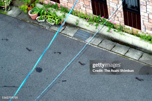 Bloody footprints believed to be those of an arson suspect, who ran away with bare feet, are seen on the road after a fire at a studio of Kyoto...