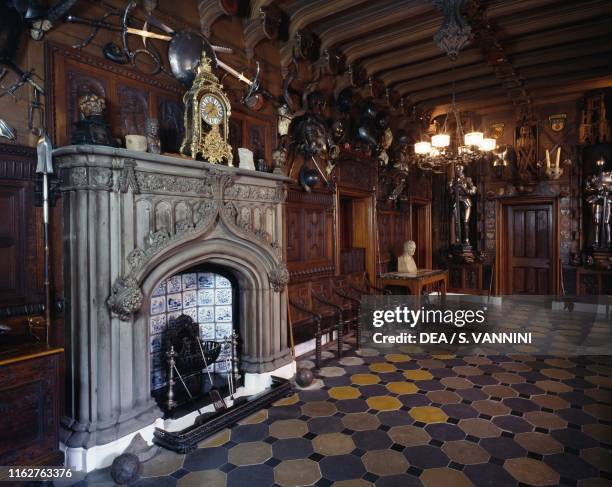 Fireplace, old armor and furniture, in the entrance hall of Abbotsford House, 1811-24, residence of the Scottish writer Walter Scott , in the...