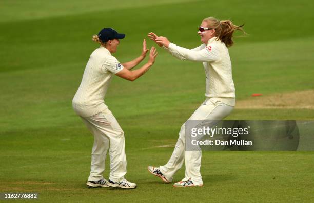 Sophie Ecclestone of England celebrates with Katherine Brunt of England after taking the wicket of Meg Lanning of Australia during the Kia Women's...