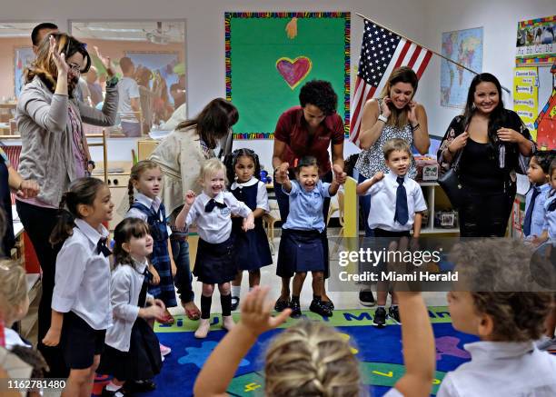 Teacher Kelly Barge leads parents and her Pre-K students in song to reduce the stress and anxiety during the first day of school on Monday, Aug. 19,...