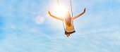 Woman on a swing with blue sky