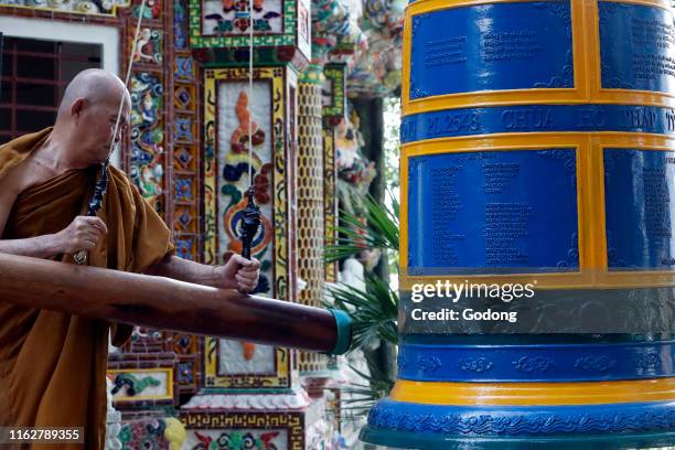 Ho Phap buddhist temple. Young monk ringing bell in monastery. Vung Tau. Vietnam.