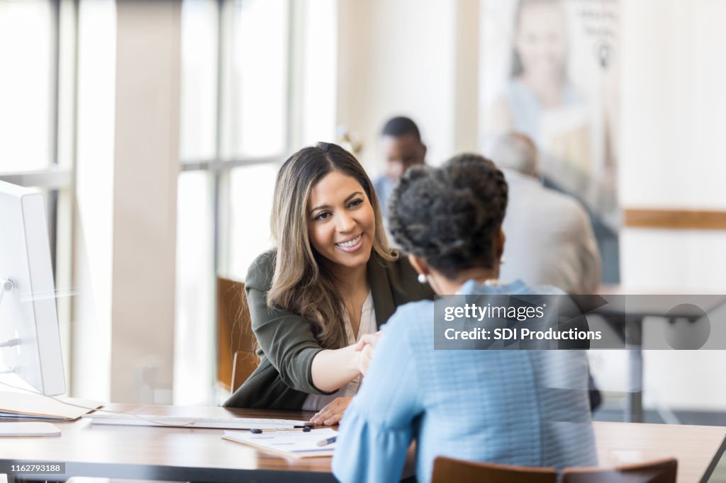 When the loan is processed, bank manager shakes customer's hand