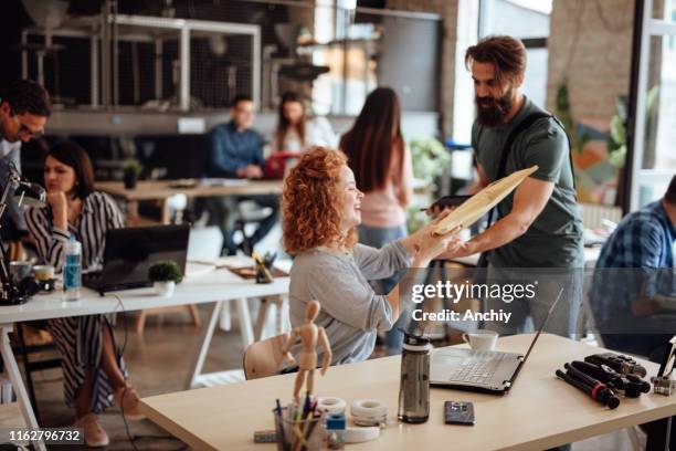 Woman Getting A Parcel From Delivery Man High-Res Stock Photo