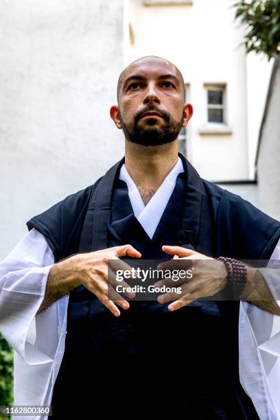 Zen sesshin in Paris, France. Retreatant practising qi gong.