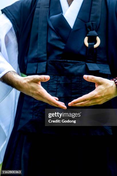 Zen sesshin in Paris, France. Retreatant practising qi gong.