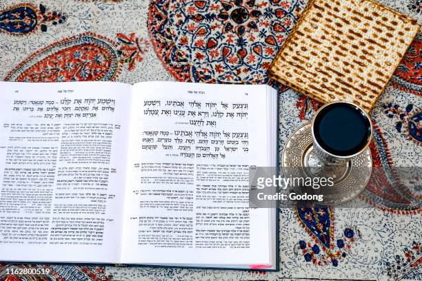 Passover Seder Haggadah in a Jerusalem jewish home, with wine and matsa.