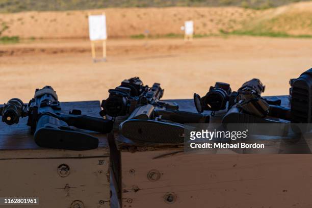 semi-automatic ar-15 style carbine rifles staged at outdoor range - semi automatic pistol stock pictures, royalty-free photos & images