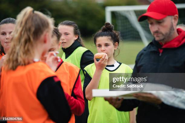 donuts after football practice - eating with a bib stock pictures, royalty-free photos & images