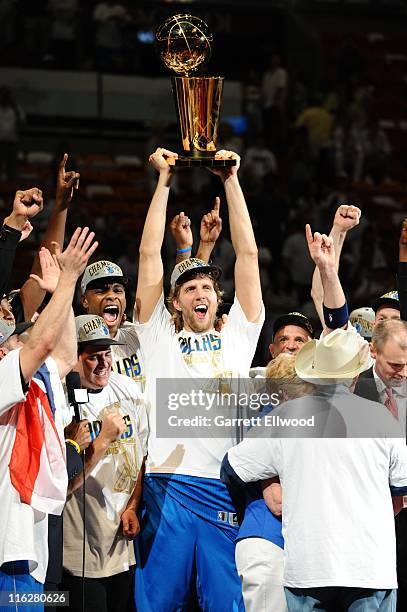 Dirk Nowitzki of the Dallas Mavericks lifts the Larry O'Brien Trophy in celebration after defeating the Miami Heat in Game Six of the 2011 NBA Finals...