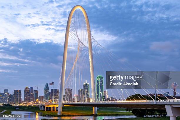 margaret hunt hill bridge with dallas skyline in the background - dallas margaret hunt hill bridge stock pictures, royalty-free photos & images