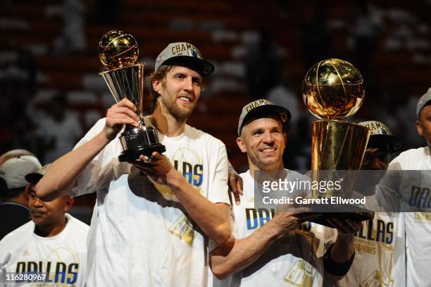 Dirk Nowitzki and Jason Kidd of the Dallas Mavericks hold the MVP and Larry O'Brien Trophies in celebration after defeating the Miami Heat in Game...
