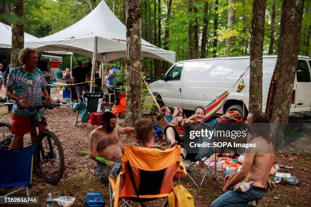 Attendees gather near the stage during the Yasgur Road Reunion at Max Yasgur's farm during 50th Anniversary of Woodstock celebrations near Bethel....