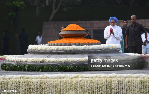 Former Indian Prime Minister Manmohan Singh pays tribute during a memorial ceremony for the 75th birth anniversary of former Indian Prime Minister...