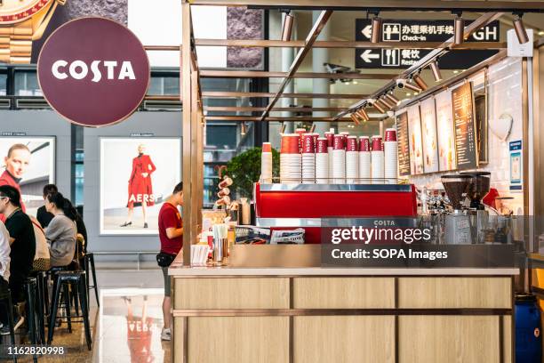 Customers seen at the British multinational coffeehouse company Costa Coffee store in Shanghai Hongqiao International Airport.