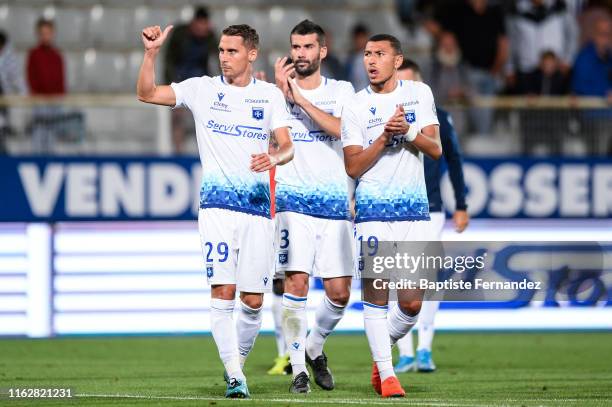 Auxerre's forward Remy Dugimon, Auxerre's defender Quentin Bernard and Auxerre's forward Yanis Begraoui salute the fans after the French Ligue 2...