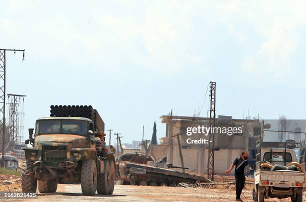 Syrian government forces gather near the town of Khan Shaykhun in the southern countryside of the rebel-held Idlib province on August 18, 2019. - A...