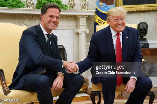 President Donald Trump and Dutch Prime Minister Mark Rutte pose for photographs after talking to reporters in the Oval Office at the White House July...