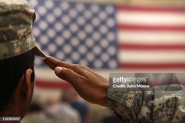 Soldier salutes the flag during a welcome home ceremony for troops arriving from Afghanistan on June 15, 2011 to Fort Carson, Colorado. More than 500...