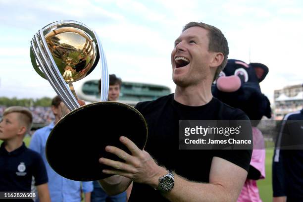 England and Middlesex captain Eoin Morgan shows the ICC Cricket World Cup trophy to fans as he takes part in a lap of honor during a interval during...