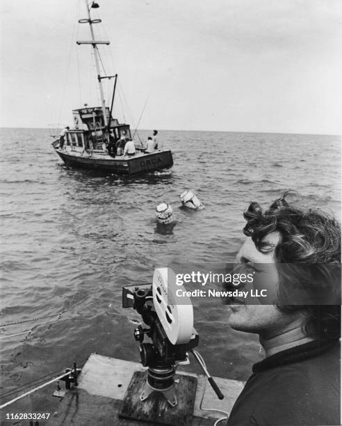 Martha's Vineyard, Mass.: Steven Spielberg waits for the crew to start filming a scene of Jaws with the actors on a boat in the Nantucket Sound off...