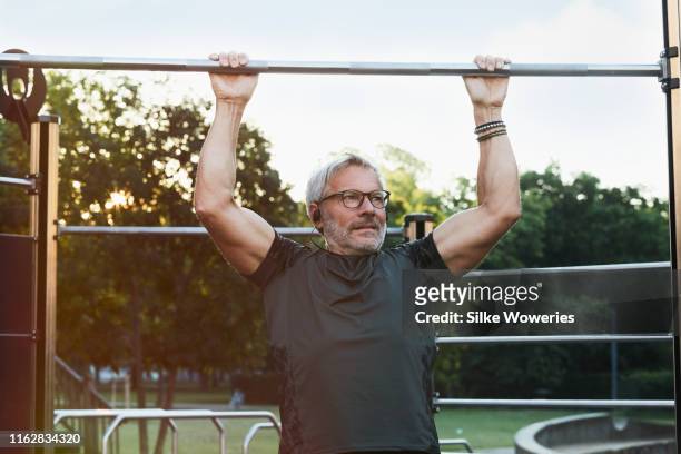 portrait of an active senior man doing exercise in the city of berlin - sports training stock-fotos und bilder