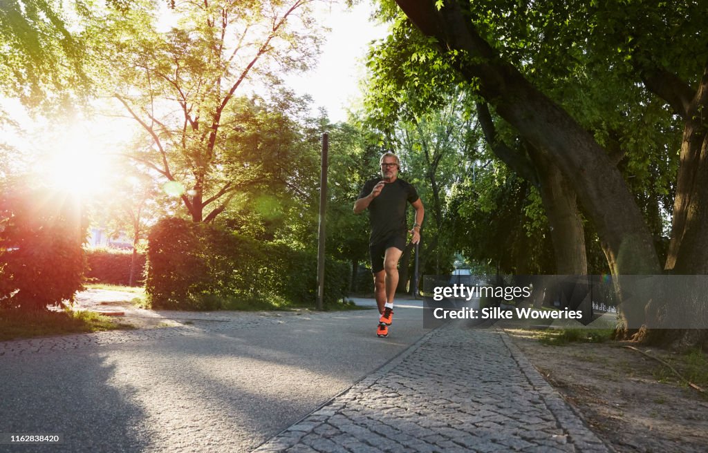 Portrait of an active senior man doing exercise in the city of Berlin