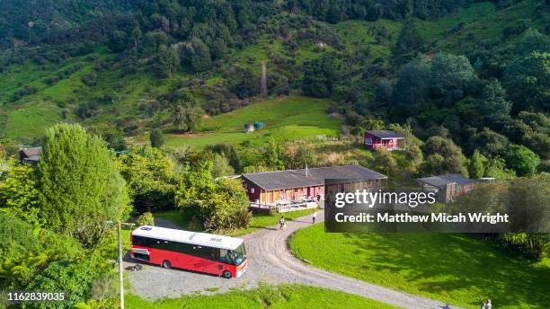 a tour bus drops off passeners at a local farm stay in the blue duck forest. - summer camping new zealand stock pictures, royalty-free photos & images