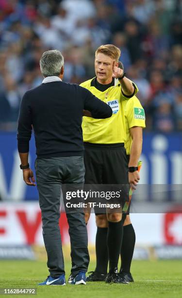 Head coach Robin Dutt of VfL Bochum receives the yellow card by Referee Christian Dingert after the Second Bundesliga match between Hamburger SV and...