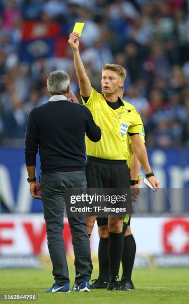 Head coach Robin Dutt of VfL Bochum receives the yellow card by Referee Christian Dingert after the Second Bundesliga match between Hamburger SV and...