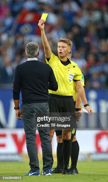 Head coach Robin Dutt of VfL Bochum receives the yellow card by Referee Christian Dingert after the Second Bundesliga match between Hamburger SV and...