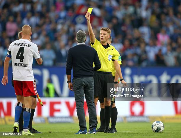 Head coach Robin Dutt of VfL Bochum receives the yellow card by Referee Christian Dingert after the Second Bundesliga match between Hamburger SV and...