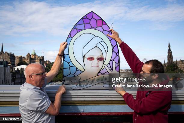 Centre manager Peter Law and his assistant Malcolm Moore take a closer look at a stain-glass window that features Scottish singer-songwriter Lewis...
