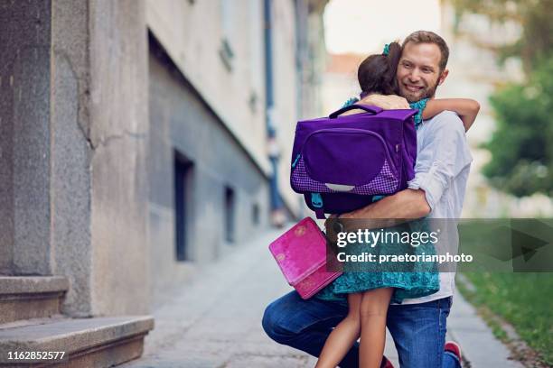 father is sending his daughter to school - first day school hug stock pictures, royalty-free photos & images