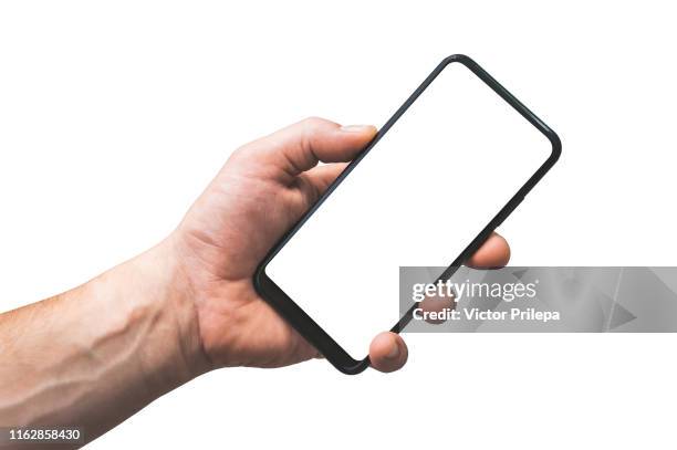 mock up smartphone isolate in hand man - closeup, on a white background. - hands holding smart phone fotografías e imágenes de stock