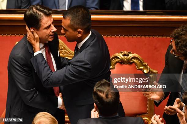 Italian Prime Minister Giuseppe Conte is congratulated by Deputy Prime Minister and Minister of Economic Development, Labour and Social Policies,...