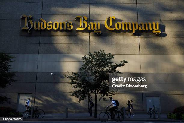 Pedestrians and a cyclist pass a Hudson's Bay Co. Store in Toronto, Ontario, Canada, on Monday, Aug. 19, 2019. Canadian private equity firm Catalyst...