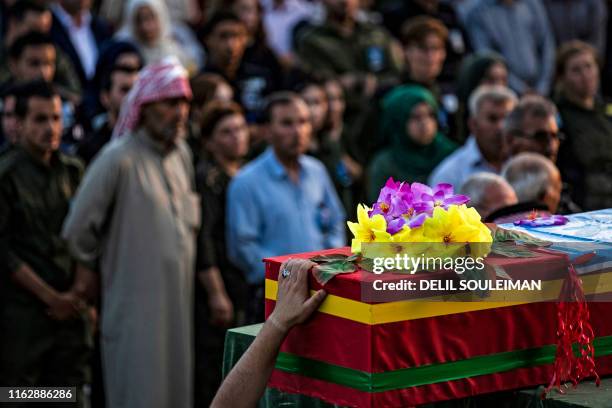 Members of the Kurdish Internal Security Police Force of Asayesh and locals attend the funeral of a fellow police officer, who was killed in a car...