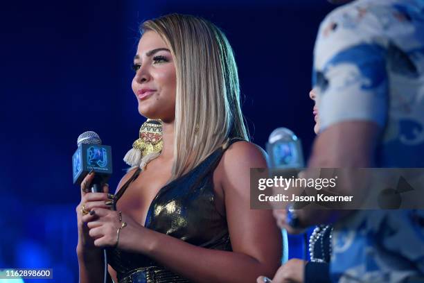 MIgbelis Castellano speaks on stage during Premios Juventud 2019 at Watsco Center on July 18, 2019 in Coral Gables, Florida.