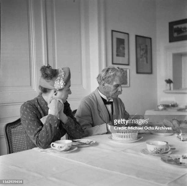 Alsatian polymath, humanitarian, writer and physician Albert Schweitzer eating cherries with Solange Gauthier Karsh, 1958.