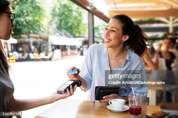 woman making card payment. - contactless payment retail stock pictures, royalty-free photos & images