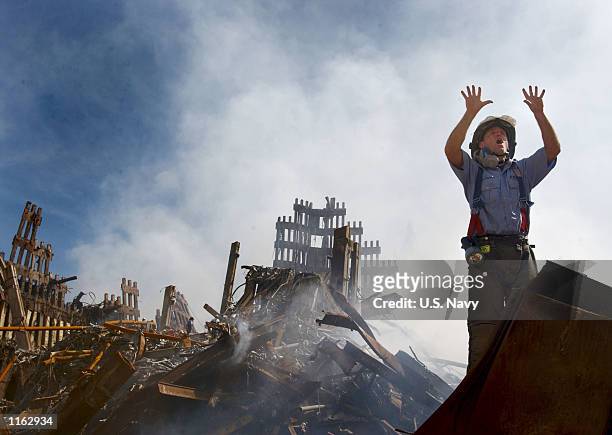 New York City fireman calls for 10 more rescue workers to make their way into the rubble of the World Trade Center September 14, 2001 days after the...