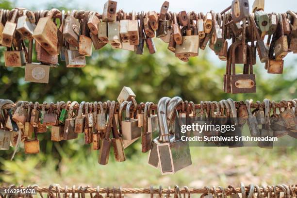 close-up of love locks hanging on fence - pont des arts padlocks stock pictures, royalty-free photos & images