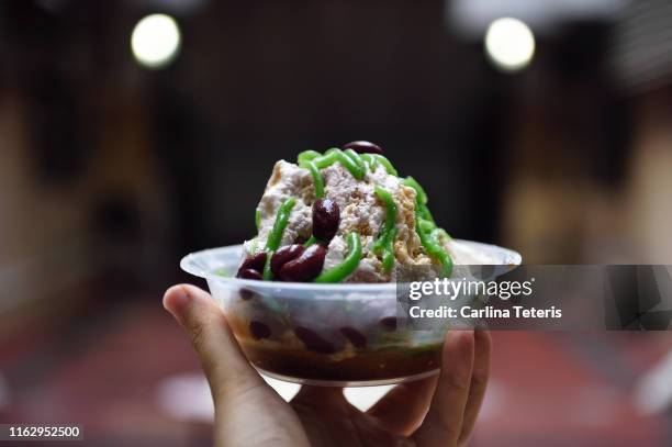 hand holding a bowl of ice chendol - coconut shaving stock pictures, royalty-free photos & images